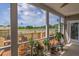 Relaxing screened-in porch with outdoor seating, potted plants, and scenic views at 7875 Berry Manor Ln, Edisto Island, SC 29438