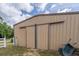 Exterior shot of storage building, showcasing its siding and double door entrance at 7875 Berry Manor Ln, Edisto Island, SC 29438
