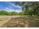 Spacious yard with white fencing under a blue sky at 7875 Berry Manor Ln, Edisto Island, SC 29438