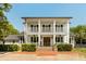 Charming two-story home with a double front porch, brick walkway, and manicured landscaping at 930 Richter Way, Mount Pleasant, SC 29464