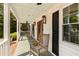 Inviting front porch featuring classic rocking chairs, wood flooring, and a charming wooden door at 930 Richter Way, Mount Pleasant, SC 29464