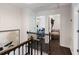 Hallway view featuring dark hardwood floors, white walls, and views into bedrooms with eye-catching decor at 930 Richter Way, Mount Pleasant, SC 29464