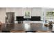Modern kitchen featuring stainless steel appliances, sleek black countertops, and ample cabinet space at 930 Richter Way, Mount Pleasant, SC 29464