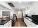Bright open kitchen with modern appliances, white cabinets, dark counter tops, and hardwood floors at 930 Richter Way, Mount Pleasant, SC 29464