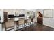 Stylish kitchen featuring a spacious island with seating, black countertops, and stainless steel appliances at 930 Richter Way, Mount Pleasant, SC 29464