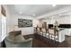 Open-concept living space with kitchen featuring a zebra print wall art, hardwood floors, and modern lighting at 930 Richter Way, Mount Pleasant, SC 29464