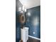 A modern half-bath with a striking mirror and dark blue walls at 930 Richter Way, Mount Pleasant, SC 29464