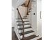 Classic staircase with dark wood treads and a white painted riser at 930 Richter Way, Mount Pleasant, SC 29464