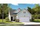 Charming single-Gathering home featuring a two-car garage, stone accents, and lush landscaping at 1017 Sagegrass St, Summerville, SC 29485