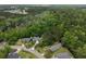 Aerial view of a home nestled within a lush, wooded neighborhood, highlighting its serene and private setting at 1061 Reverend Joseph Heyward Rd, Charleston, SC 29414