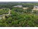 A panoramic view showcases a neighborhood adjacent to lush woodlands and winding roads at 1061 Reverend Joseph Heyward Rd, Charleston, SC 29414