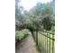 Spacious backyard with black iron fence offers privacy and security within the mature landscaping at 1061 Reverend Joseph Heyward Rd, Charleston, SC 29414
