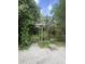 Secluded backyard features custom pergola entrance, mature landscaping, and a charming stone walkway at 1061 Reverend Joseph Heyward Rd, Charleston, SC 29414