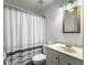 Well-lit bathroom featuring a striped shower curtain, toilet, and vanity at 1061 Reverend Joseph Heyward Rd, Charleston, SC 29414