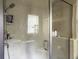 Modern tiled shower with glass door showcasing the shower head and included toiletries at 1061 Reverend Joseph Heyward Rd, Charleston, SC 29414