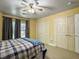 Inviting bedroom with three closets, yellow walls, carpet, and natural light from the window at 1061 Reverend Joseph Heyward Rd, Charleston, SC 29414