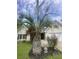 Charming home featuring verdant landscaping, mature palms, and meticulous front yard at 1061 Reverend Joseph Heyward Rd, Charleston, SC 29414