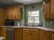 Bright kitchen features granite counters, wooden cabinets, and stainless-steel dishwasher at 1061 Reverend Joseph Heyward Rd, Charleston, SC 29414