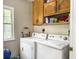 Functional laundry room featuring cabinetry, washer, and dryer, with a window for natural light at 1061 Reverend Joseph Heyward Rd, Charleston, SC 29414