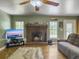 Comfortable living room with a brick fireplace, hardwood floors, and natural lighting at 1061 Reverend Joseph Heyward Rd, Charleston, SC 29414