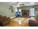 Spacious living area with a cozy brick fireplace, hardwood floors, and plenty of natural light at 1061 Reverend Joseph Heyward Rd, Charleston, SC 29414