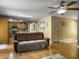 Open-concept living room boasts hardwood floors, a ceiling fan, and a comfortable brown sofa at 1061 Reverend Joseph Heyward Rd, Charleston, SC 29414