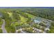 Aerial view of the golf course, tennis courts, and pool area at a Primary-planned community at 112 Riviera Dr, Summerville, SC 29483