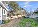 The backyard features a storage shed, raised garden beds, deck, and ample space for outdoor activities at 112 Riviera Dr, Summerville, SC 29483