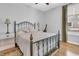 Cozy bedroom with an iron bed frame, hardwood floors, and natural light at 112 Riviera Dr, Summerville, SC 29483