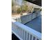 A view from the gray wood deck highlighting the white railing system and the raised garden beds in the backyard at 112 Riviera Dr, Summerville, SC 29483
