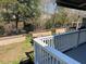 The gray painted deck offers a relaxing space with views of the fenced yard and surrounding greenery at 112 Riviera Dr, Summerville, SC 29483
