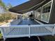 Relax on the deck with a retractable awning, overlooking the landscaped yard with raised planting beds for gardening enthusiasts at 112 Riviera Dr, Summerville, SC 29483