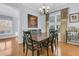 Charming dining room with a traditional chandelier, hardwood floors, and a large window with natural light at 112 Riviera Dr, Summerville, SC 29483