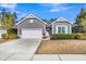 Charming single-story home with gray siding, white trim, well-manicured landscaping, and an attached garage at 112 Riviera Dr, Summerville, SC 29483