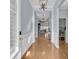 Home foyer featuring hardwood floors, white wainscoting, and a view into the living room and bedroom at 112 Riviera Dr, Summerville, SC 29483