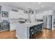 Bright kitchen featuring a large island with bar stools, white cabinets, and modern stainless steel appliances at 112 Riviera Dr, Summerville, SC 29483