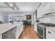 Kitchen featuring island with a sink, stainless steel appliances, white cabinets, and a view of the dining area at 112 Riviera Dr, Summerville, SC 29483