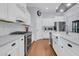 Kitchen featuring white cabinetry, stainless steel appliances, subway tile backsplash, and wood floors at 112 Riviera Dr, Summerville, SC 29483
