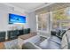 Comfortable living room with large windows, hardwood floors, and beach-themed TV programming at 112 Riviera Dr, Summerville, SC 29483