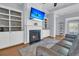 Cozy living room features a fireplace with built-in shelving, hardwood floors, and neutral color palette at 112 Riviera Dr, Summerville, SC 29483