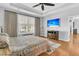 Spacious main bedroom with hardwood floors, TV, tray ceilings, and a large window at 112 Riviera Dr, Summerville, SC 29483