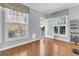 Bright sunroom with hardwood floors, multiple windows, and access to the outdoors at 112 Riviera Dr, Summerville, SC 29483