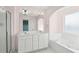 Bathroom features double vanity sinks, large mirror, and luxurious soaking tub at 1144 Clearspring Dr, Charleston, SC 29412