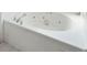 Close up of bathtub with tiled surround and hydrotherapy jets at 1144 Clearspring Dr, Charleston, SC 29412