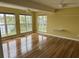 Bright bedroom with hardwood floors and large windows with a view of the lake at 1144 Clearspring Dr, Charleston, SC 29412
