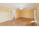 Large bedroom with gleaming hardwood floors, a ceiling fan and an en-suite bathroom with an open doorway at 1144 Clearspring Dr, Charleston, SC 29412