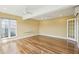 Bedroom with hardwood floors, one large window, two ceiling fans, and doorway at 1144 Clearspring Dr, Charleston, SC 29412