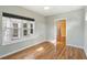 Cozy bedroom with hardwood floors, bright windows, and a doorway leading to another room at 1144 Clearspring Dr, Charleston, SC 29412