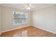 Cozy bedroom features hardwood floors, neutral walls, and natural light from a large window at 1144 Clearspring Dr, Charleston, SC 29412