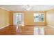 Spacious bedroom with gleaming hardwood floors, a ceiling fan, and natural light from a large window at 1144 Clearspring Dr, Charleston, SC 29412